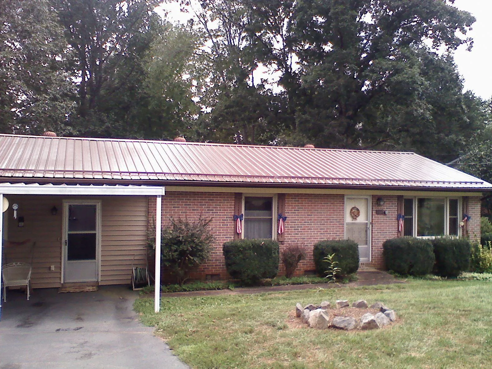 Bronze metal roof and carport on a brick ranch home — Roof Repair work by our crew in Pine Hill